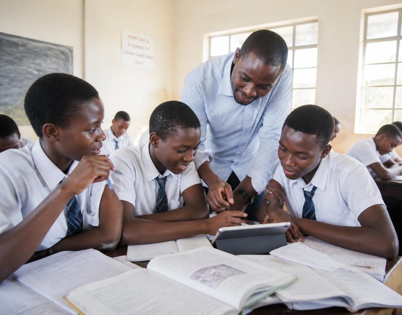 Students learning together with a teacher in a bright classroom